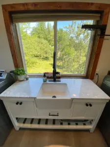 Homeowner’s new sink is very functionable with great depth to the sink as well as storage space in the cabinet and that window lets in so much light.