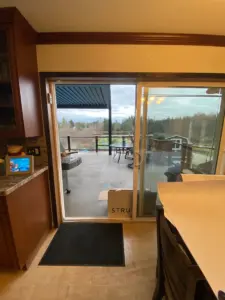 Homeowners view through existing slider to backyard.