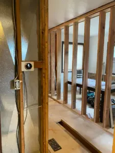 Progress of new bathroom location being framed in.